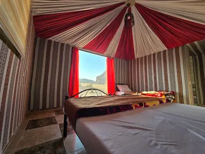 a bedroom with two beds in a tent at Amira Luxury Camp in Wadi Rum