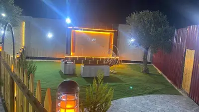 a house with a stage in a yard at night at مزرعة الخربه in Khirbat Abū al Khass