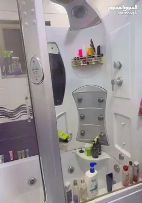 a bathroom with a shower and a sink and a mirror at مزرعة الخربه in Khirbat Abū al Khass