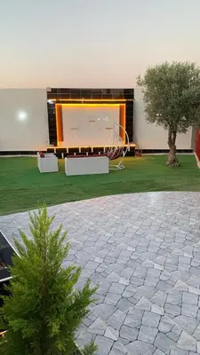 a large screen in a building with a tree at مزرعة الخربه in Khirbat Abū al Khass