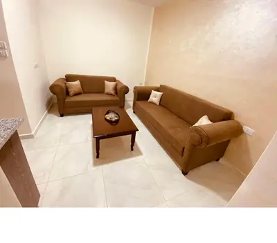 a living room with two couches and a coffee table at New Roman's kingdom in Madaba