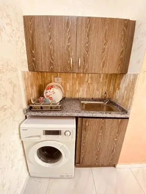 a kitchen with a washing machine and a sink at New Roman's kingdom in Madaba