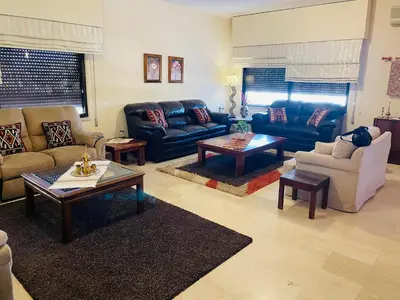 a living room with couches and a coffee table at شقة مفروشة الدوار الخامس in Amman