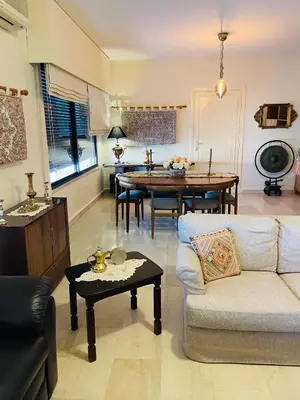 a living room with a couch and a table at شقة مفروشة الدوار الخامس in Amman