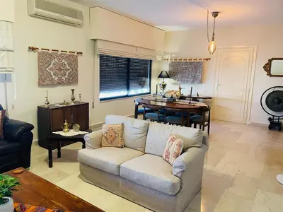 a living room with a couch and a table at شقة مفروشة الدوار الخامس in Amman