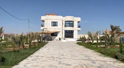 a white house with a road in front of it at شاليه ريست سي Rest Sea Chalet