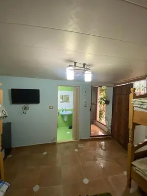 an empty living room with a bathroom and a television at اربد ام قيس طريق درب الاردن in Um Qeis
