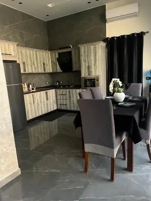 a kitchen and dining room with a table and chairs at Villa Ohaio in Amman