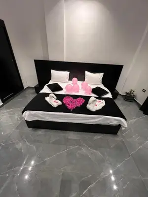 a large bed with pink stuffed animals on it at Villa Ohaio in Amman