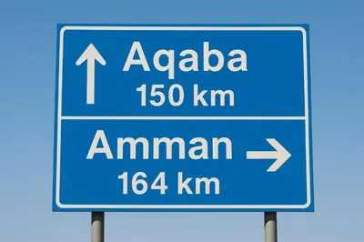 a blue street sign with the name ofza km at Halfway motel in An Namatah