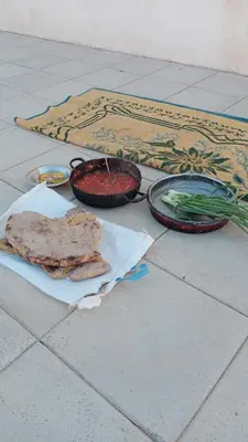 a table with two bowls of food and vegetables at Halfway motel in An Namatah