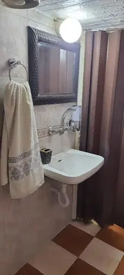 a bathroom with a sink and a towel hanging on the wall at Stone house in Amman
