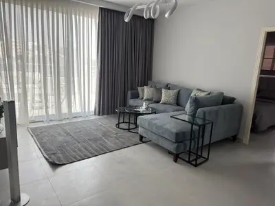 a living room with a couch and a table at Roof 99 in Amman