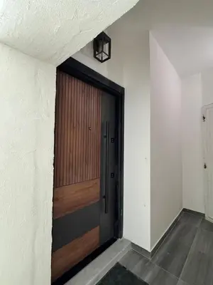 a hallway with a wooden door in a room at Roof 99 in Amman