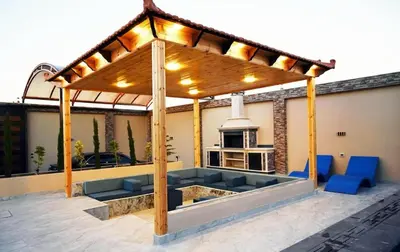 a pergola on top of a house with blue chairs at For daily, weekly monthly and yearly stays in Amman