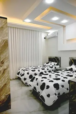 two beds in a room with black and white at For daily, weekly monthly and yearly stays in Amman