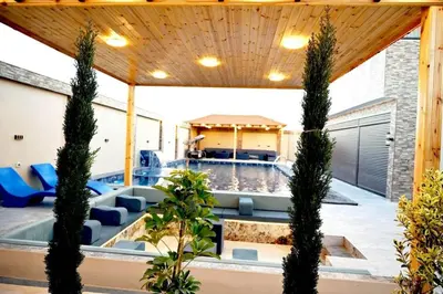 a pool in a house with trees in the yard at For daily, weekly monthly and yearly stays in Amman