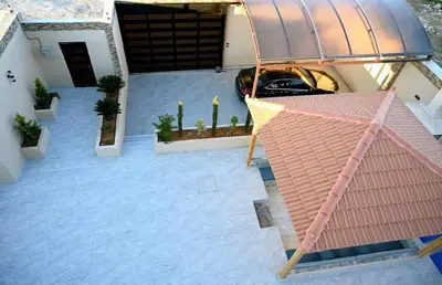 an aerial view of a house with a car parked at For daily, weekly monthly and yearly stays in Amman