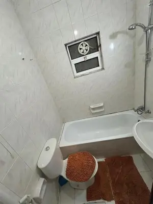 a bathroom with a sink and a toilet and a bath tub at Toum's Apartments 2 in Amman