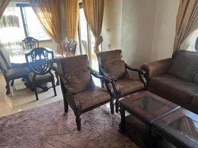 a living room with a couch and chairs and a table at كرم الضيافة in Amman