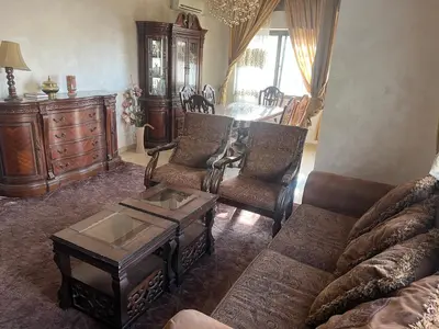 a living room with a couch and chairs and a table at كرم الضيافة in Amman