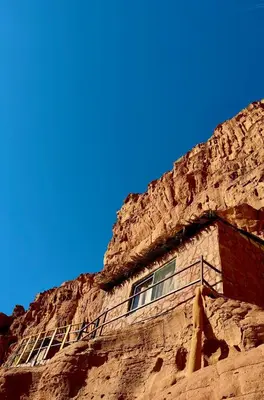 a building in the side of a cliff at Bedouin Secret Cave in Wadi Rum