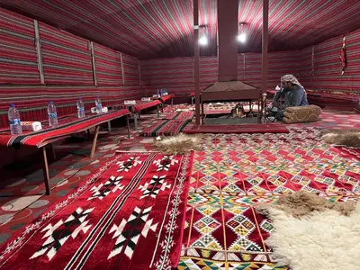 a large room with a red rug on the floor at Desert Key Camp in Wadi Rum