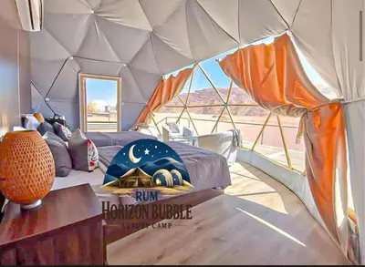 a room with a bed in a tent at RUM HORIZON BUBBlE LUXURY CAMP in Wadi Rum