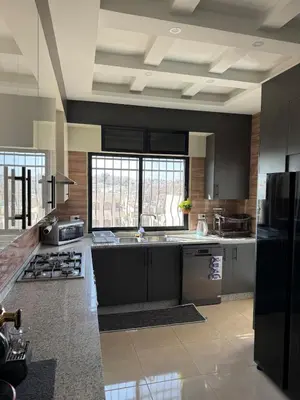 a large kitchen with a sink and a stove at 2bd apartment sport city in Amman