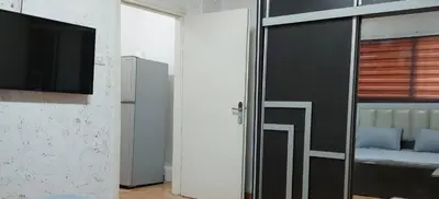 a bedroom with a bed and a sliding door with a television at Stone house in Amman