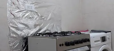 a kitchen with a stove with plastic wrap on it at Stone house in Amman