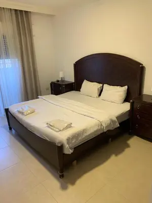 a bedroom with a large bed with two towels on it at dabouq 3bedroom near all services JRE in Amman