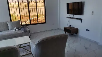 a living room with a couch and chairs and a table at Rest Sea Chaliet & Farm