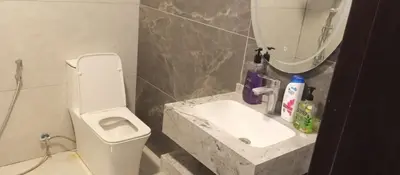 a bathroom with a sink and a toilet and a mirror at Rest Sea Chalet Private Room