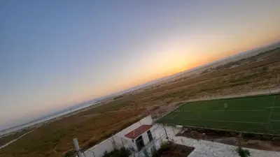 an aerial view of a soccer field with the sunset in the background at Rest Sea Chalet Private Room