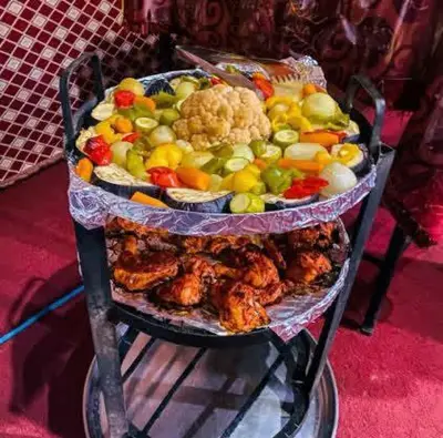 a three tiered display of different types of food at Wadi Rum Bubble Dream in Wadi Rum
