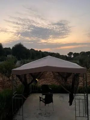 a large tent with two chairs under it at Pine Country Farm Stay in Umm al Manābī‘