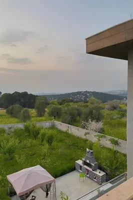 a view from the balcony of a house at Pine Country Farm Stay in Umm al Manābī‘