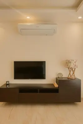a living room with a flat screen tv on a wall at Elite Apartment Compound in Amman
