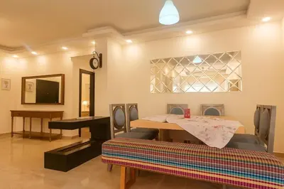 a dining room with a table and a piano at Elite Apartment Compound in Amman
