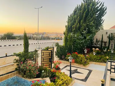 a view of a garden with flowers and plants at Furnished Villa in Andalusian Compound for Rent in Madaba