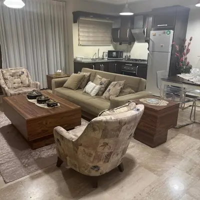 a living room with a couch and a table and chairs at عبدون الشمالي -بالقرب من السفارة البريطانية in Amman