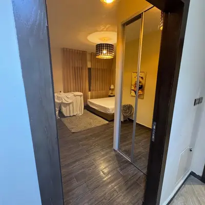 a room with a mirror and a bedroom with a bed at عبدون الشمالي -بالقرب من السفارة البريطانية in Amman