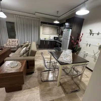 a living room with a couch and a table at عبدون الشمالي -بالقرب من السفارة البريطانية in Amman