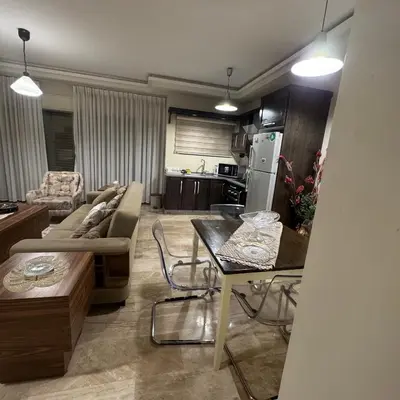 a living room with a couch and a table at عبدون الشمالي -بالقرب من السفارة البريطانية in Amman