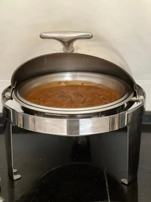 a pot of food in a pan on a stove at RUM NADINE LUXURY CAMP & Bubbles Hotel in Wadi Rum