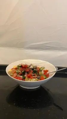 a bowl of vegetables is sitting on a table at RUM NADINE LUXURY CAMP & Bubbles Hotel in Wadi Rum