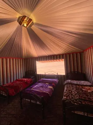 a room with two beds in a tent at Wadi Rum Nights Tents in Wadi Rum