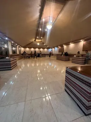 a large lobby with people walking around in a building at Sunrise Echo Camp in Wadi Rum