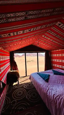 a bedroom with a bed in a tent at Desert Nights camp in Wadi Rum